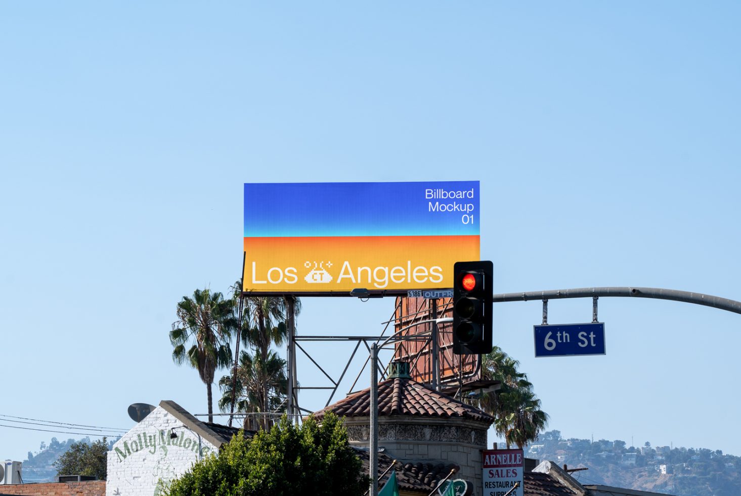 Billboard mockup with a colorful sunrise design and Los Angeles text displayed above urban scenery for advertising and design presentations.